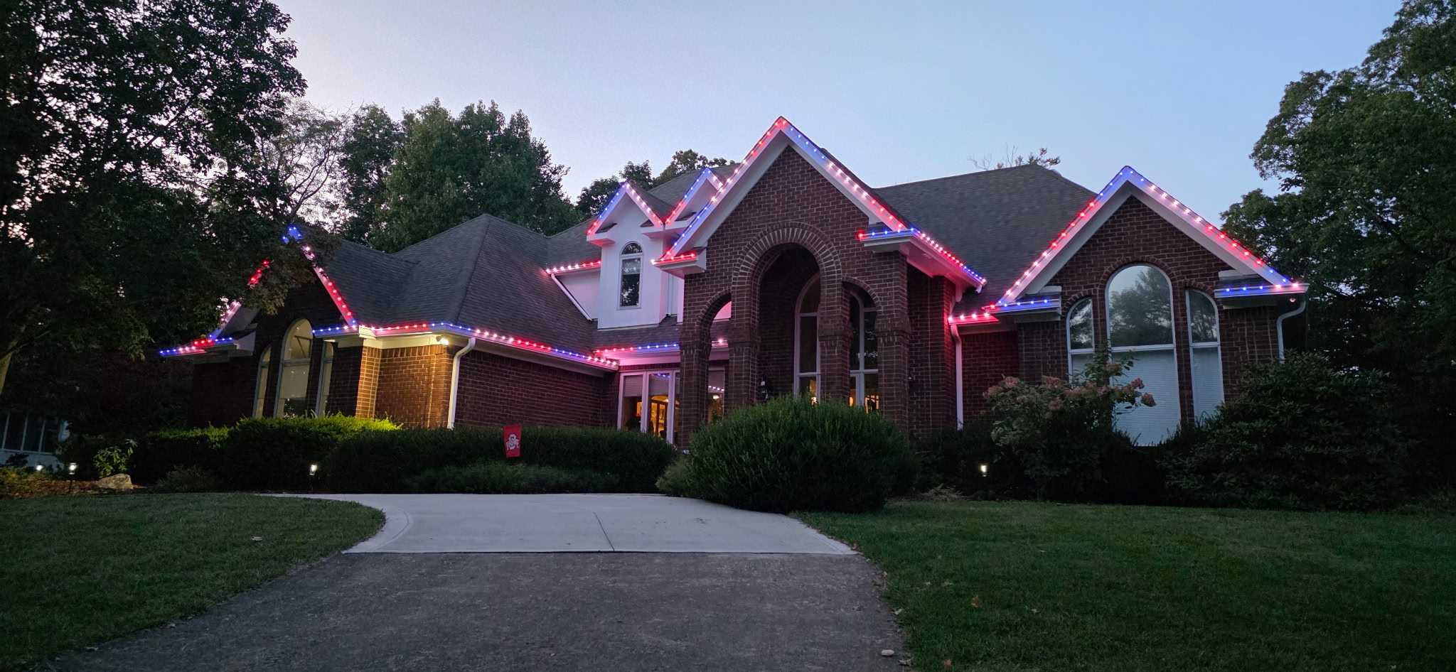 Color-changing permanent lighting installed on a brick home